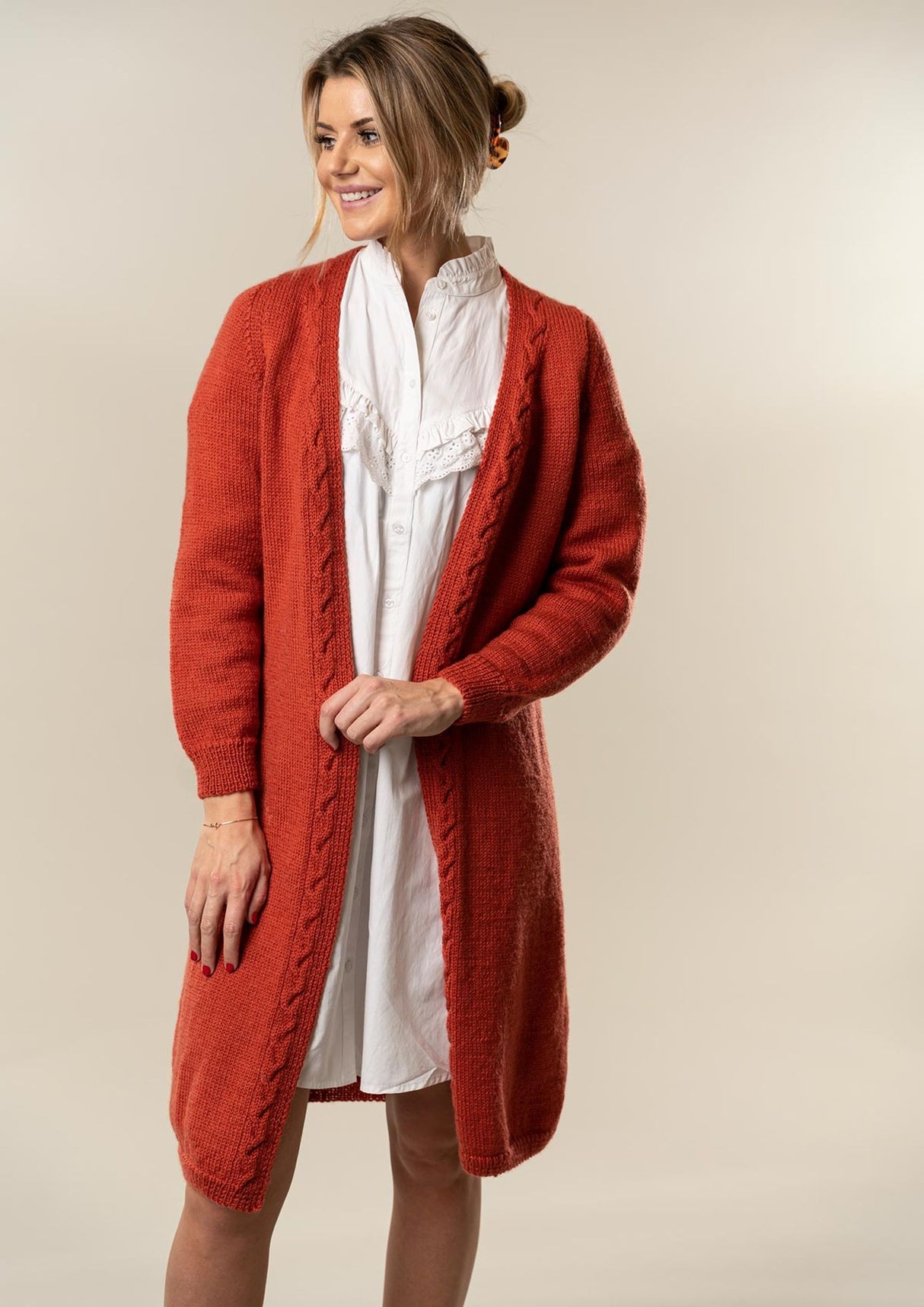 Knitted women's coat with cables