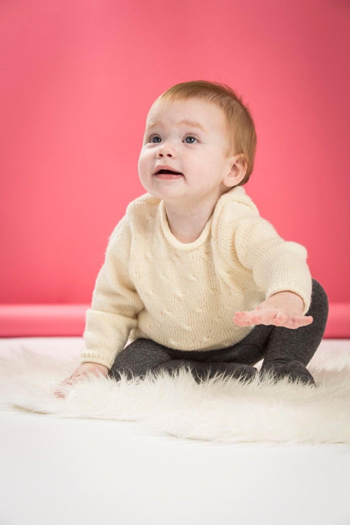 Baby sweater with small cables