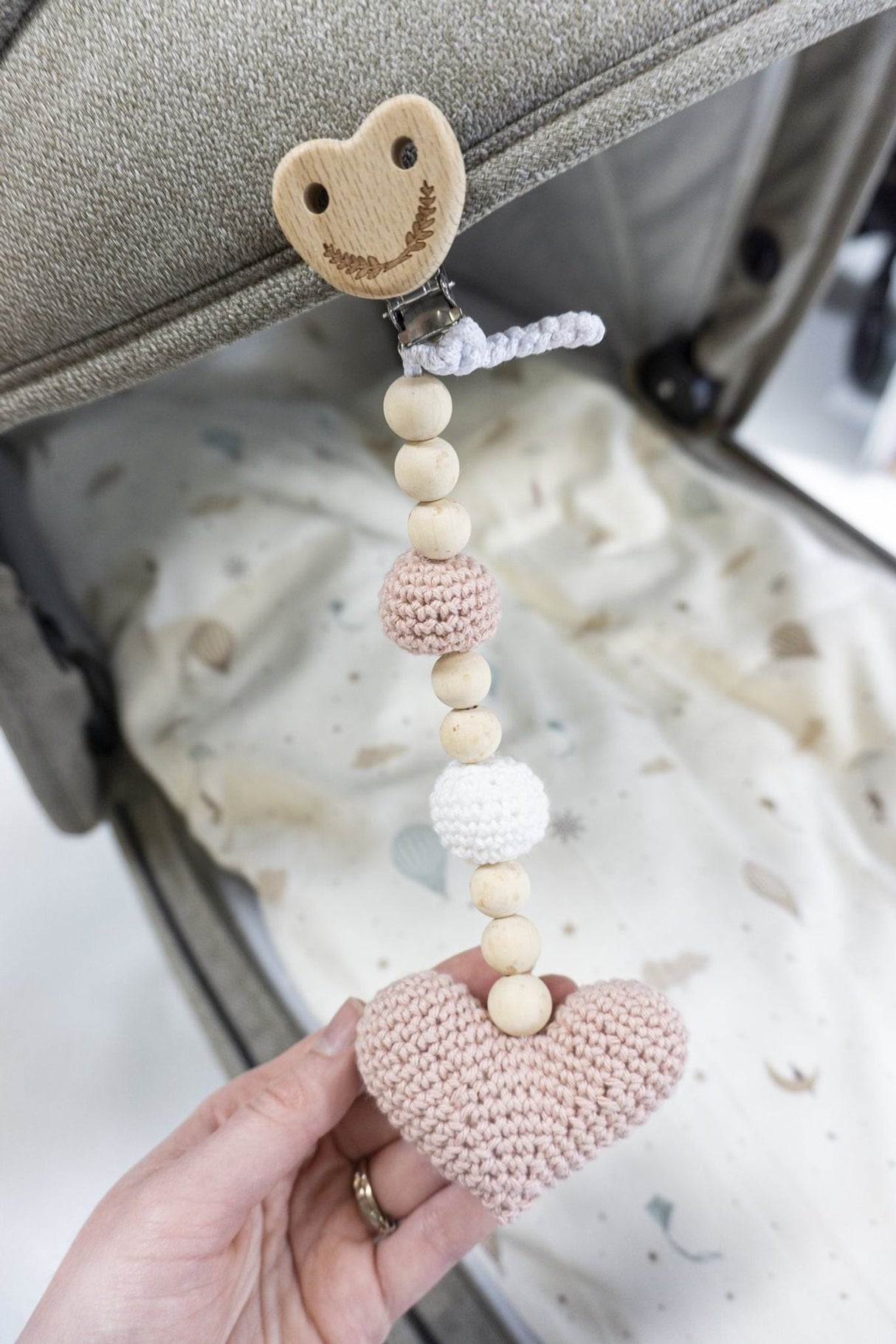 Crocheted stroller hanger with heart 