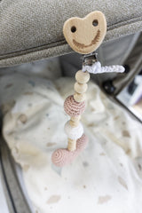 Crocheted stroller hanger with heart 